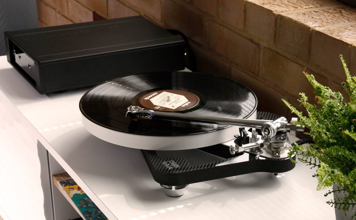 rega naia turntable with aphelion 2 cartridge and power supply lifestyle image in home, high-end vinyl replay from loud and clear hi-fi, glasgow, scotland, uk