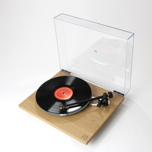 Rega P3 Turntable in new light oak finish playing vinyl offside angle, vinyl from loud and clear glasgow, scotland, uk