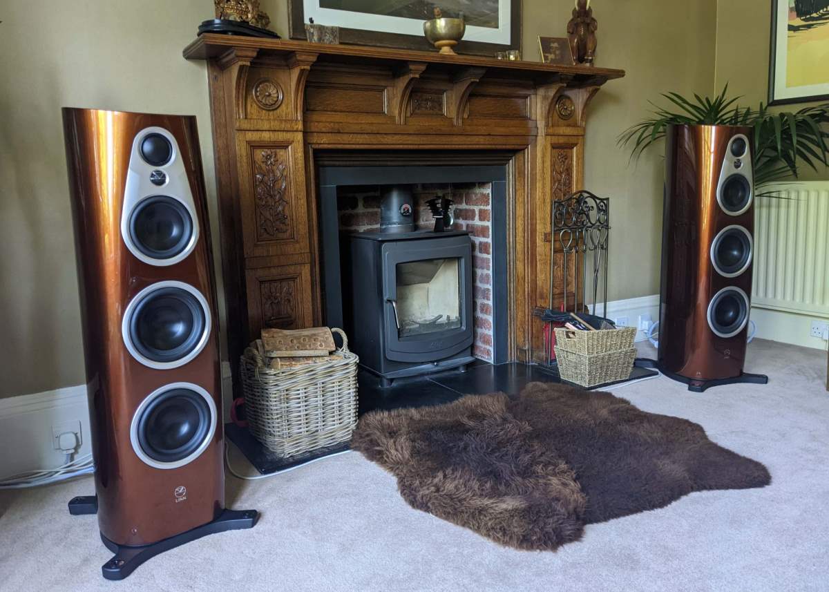 Linn 360 exakt active speakers in single malt finish at southside dem room with wood burning stove, mantelpiece in beautiful room