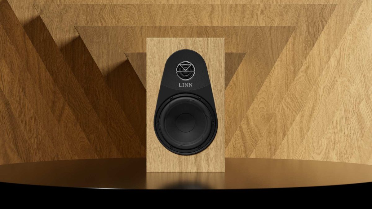 Linn 119 bookshelf speaker in Oak finish on black table with wooden Background, stereo systems from loud and clear hi-fi, glasgow, scotland, uk